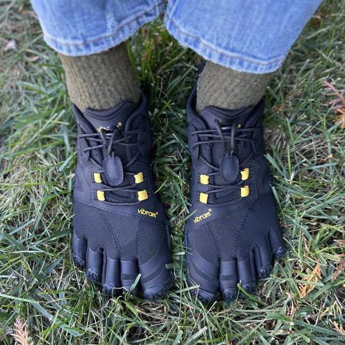 A pair of feet in Vibram Five Fingers toe shoes trail shoes for hiking