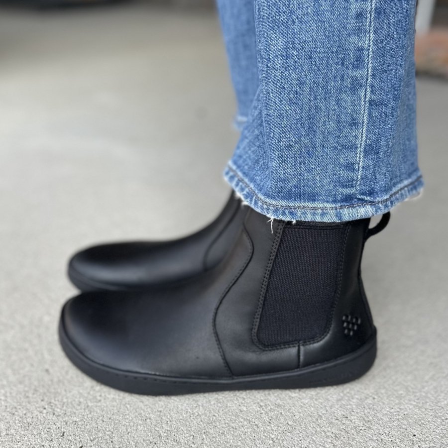 Side profile view of Black leather barefoot chelsea boots