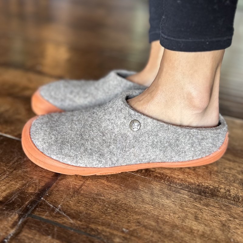 A close up side view of Wildling Shoes Slinka Sten wool barefoot slippers with a rubber outsole and short heel