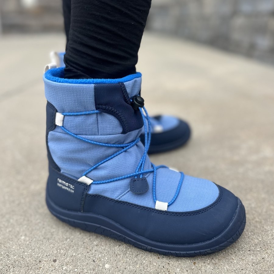 Reima Ensilumi being worn by a young child, close up from the side to show the zero drop outsole