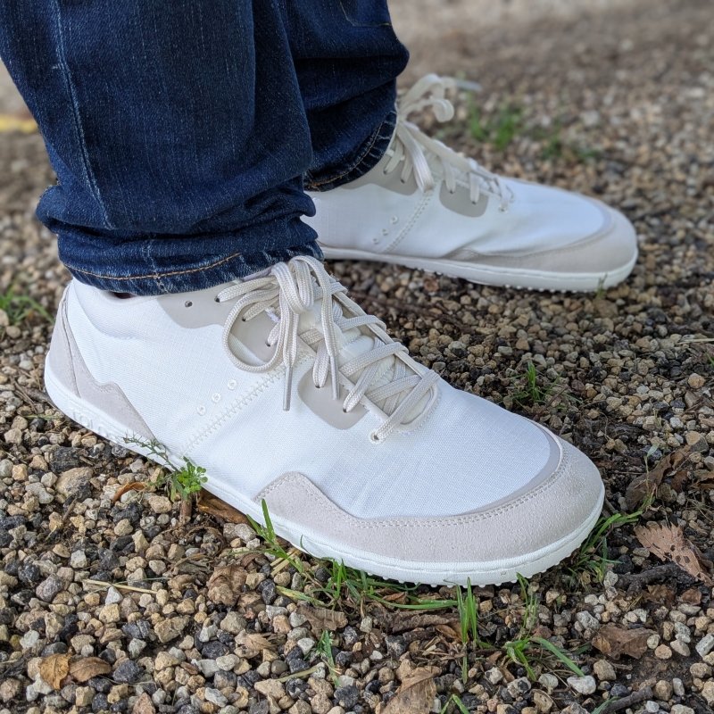 A side view of a man's feet in Tolos transition Soleil wide toe box sneakers