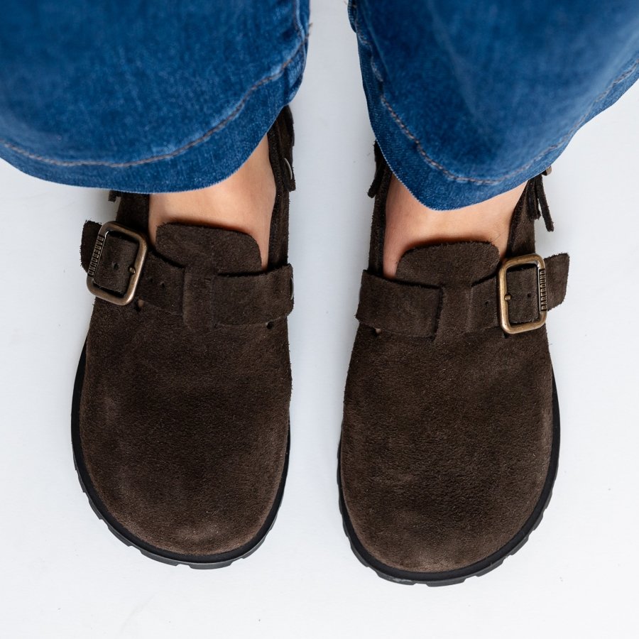 Top down close up of a person in wide leg denim wearing a pair of Barebound Ikaros barefoot clogs with a wide toe box and flexible outsole