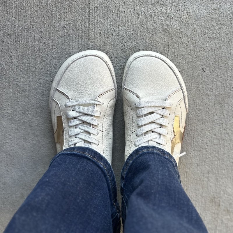 Top down look at low profile wide toe box Lono Nomad leather barefoot sneakers with metallic accents on the sides.