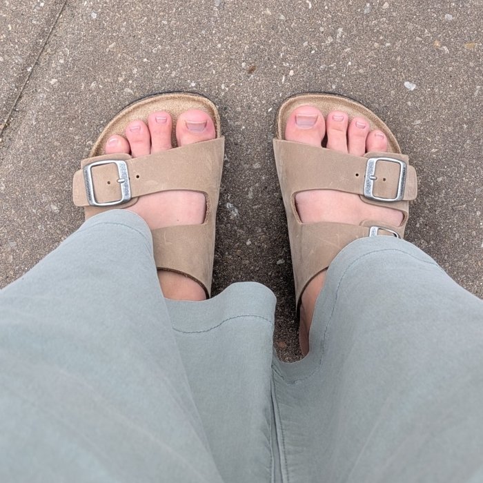 Top down view of a person's extra wide feet wearing Wyde Maia double buckle zero drop sandals.
