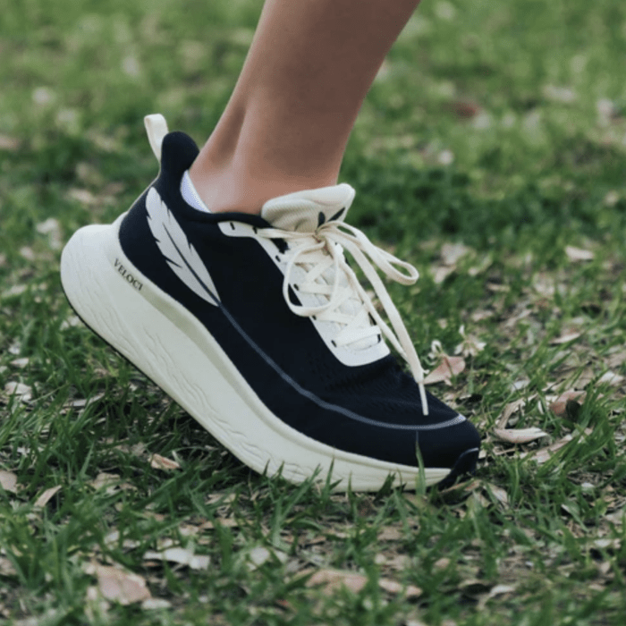 Side view of a pair of Veloci Running sneakers with high cushioning, a wide toe box, and a moderate heel drop.