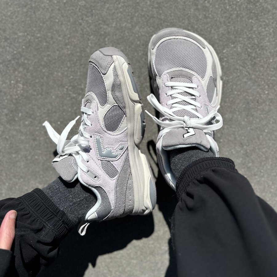A top down and side view of a person's feet in Wyde Footwear Soma gray sneakers, an extra wide toe box chunky Dad sneaker with a zero drop outsole.