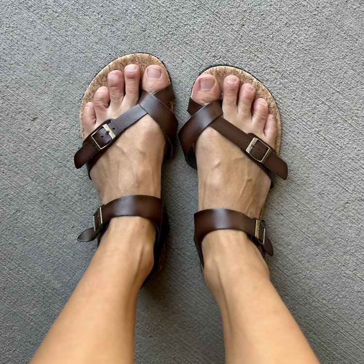 Top down look at a pair of brown non-leather barefoot adjustable sandals with a cork footbed from Rutsu