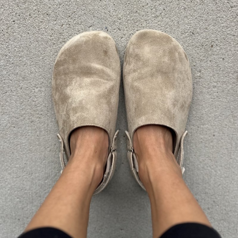 Top down view of a pair of Saguaro affordable barefoot clogs in tan microfiber with a heel strap.