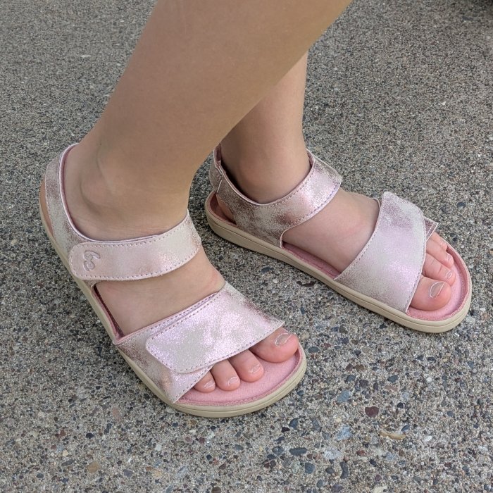 A young child's feet in a pair of Be Lenka Miami adjustable barefoot sandals with a wide toe box and slightly cushioned outsole.