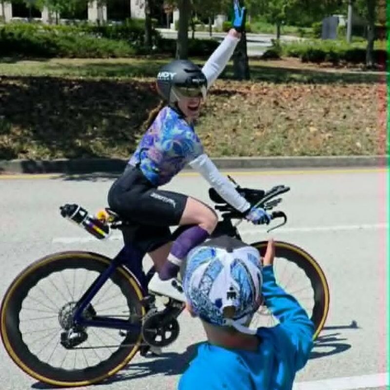 A person on a road bike cycling in Strong Feet Athletics Leviathan wide toe box cycling shoes during an ironman in Florida.