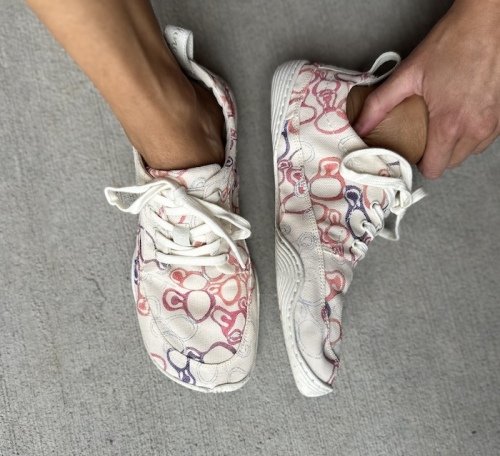 A top down and side view of a person wearing Wildling Tanuki Asawa, a paper barefoot shoe with abstract purple, pink, and lined baubles