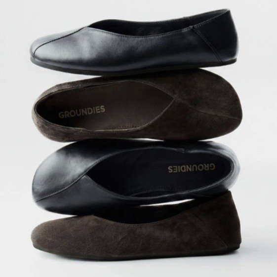 A stack of brown and black Curve barefoot ballet flats from Groundies