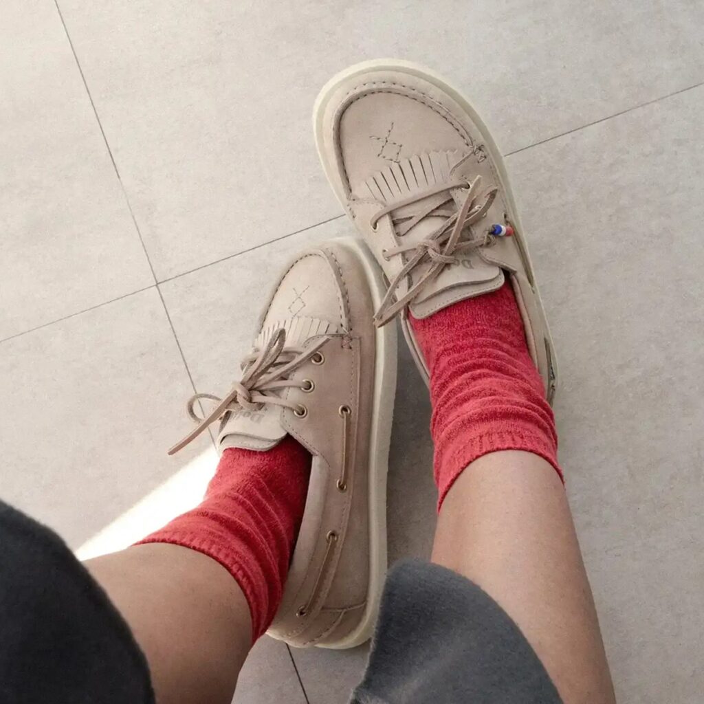Dolfie Paradise barefoot Deck loafer boat shoes in beige being worn with scrunchy coral socks