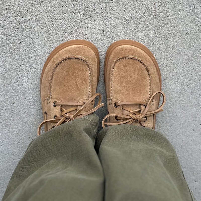 Top down view of a pair of Flamingos Life Boat Shoes with a wide toe box, worn with olive green pants
